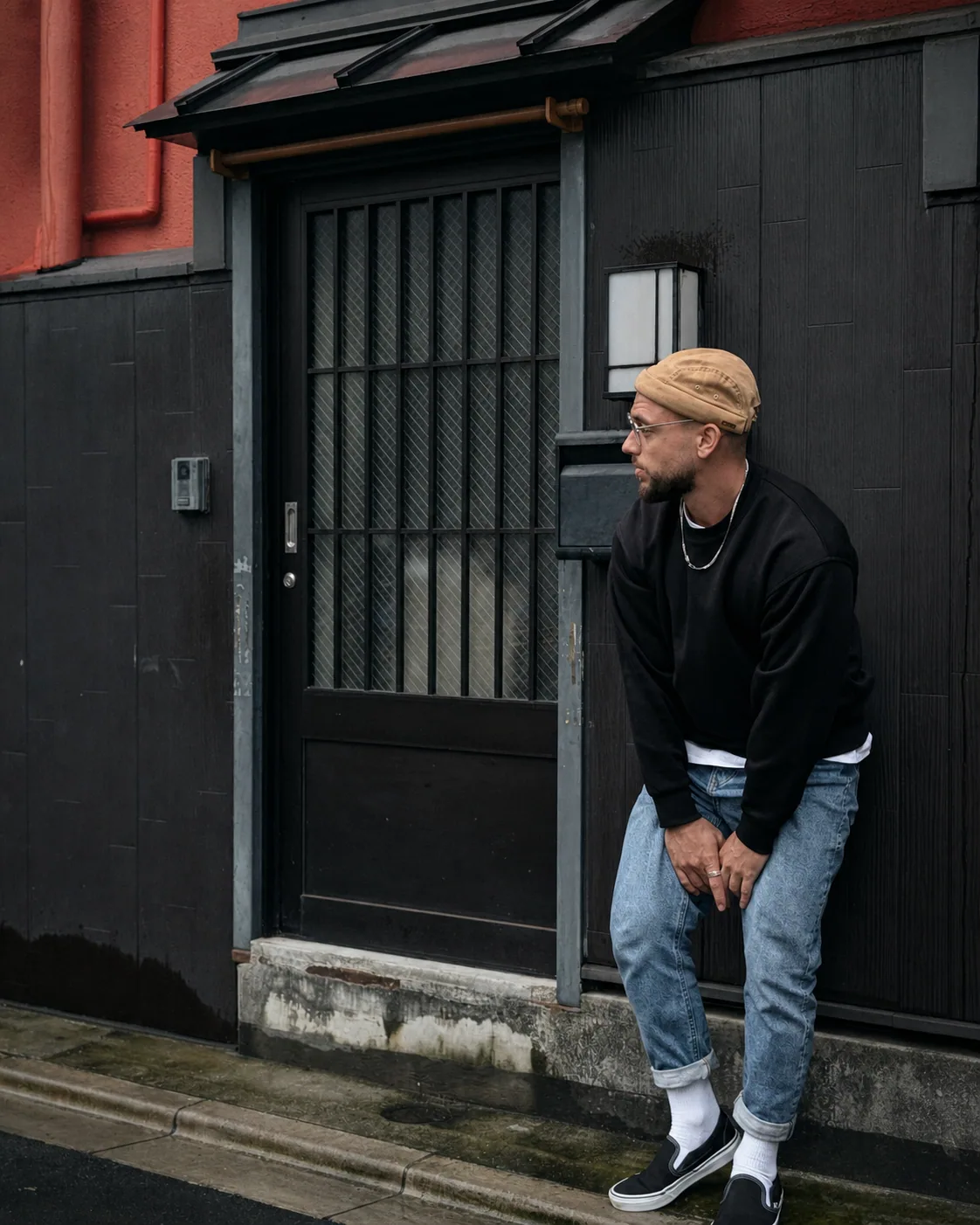 Arthur V. in front of a dark architectural facade in Tokyo
